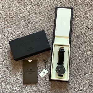 Women’s Black Daniel Wellington watch.